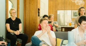 Group of employees in a room clapping hands