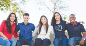 five happy coworkers sits next to each other