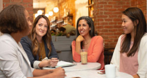 Four coworkers having a coffee break together